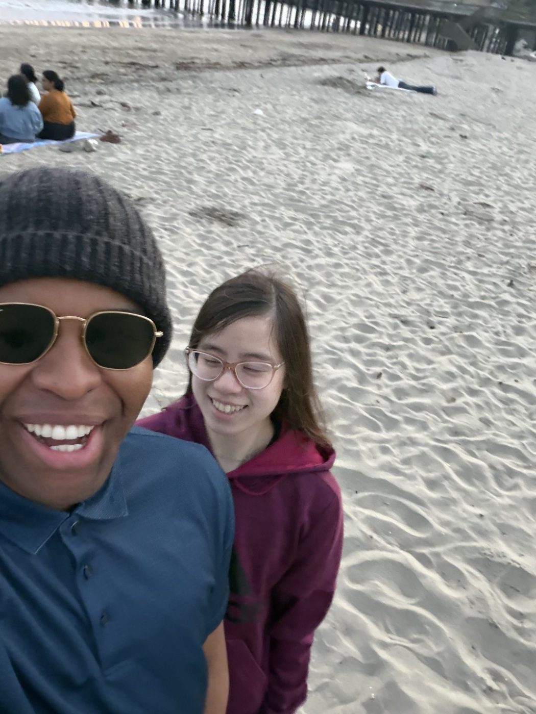 Beach selfie with a friend near a pier